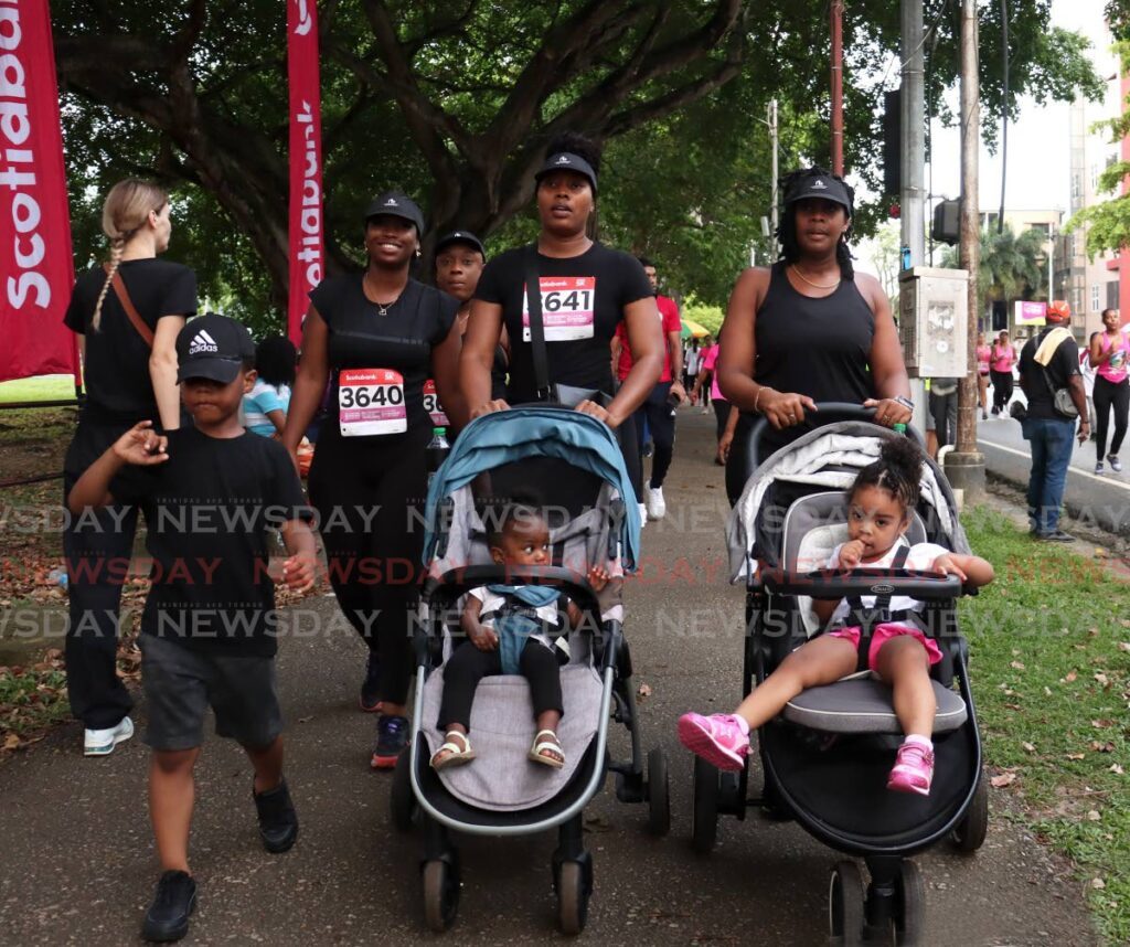 Mothers participate with their children in the Scotiabank Women Against Breast Cancer 5K 2024 at Queen's Park Savannah, Port of Spain on October 5.  - Photo by Faith Ayoung