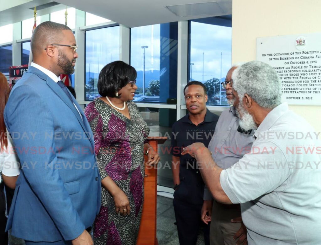 IN REMEMBRANCE: Port of Spain Mayor Chinua Alleyne, Police Commissioner Erla Harewood-Christopher, Foreign Affairs Minister Dr Amery Browne and members of the TT Friends of Cuba chat at the commemoration of the 48th anniversary of the terrorist bombing of the of Cuban Airline flight 455 in Barbados in 1976 at Piarco International Airport, Piarco on October 6. - Faith Ayoung