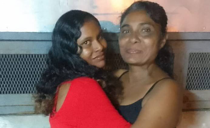 Alana De Leon hugs her mother Rosemarie Roopchand, right, in happier times. De Leon was found murdered in a house in Curepe on October 5. 
 - 