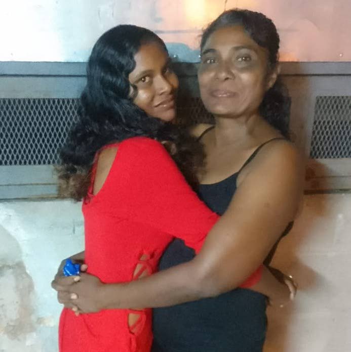 Alana De Leon hugs her mother Rosemarie Roopchand, right, in happier times. De Leon was found murdered in a house in Curepe on October 5. 
 - 