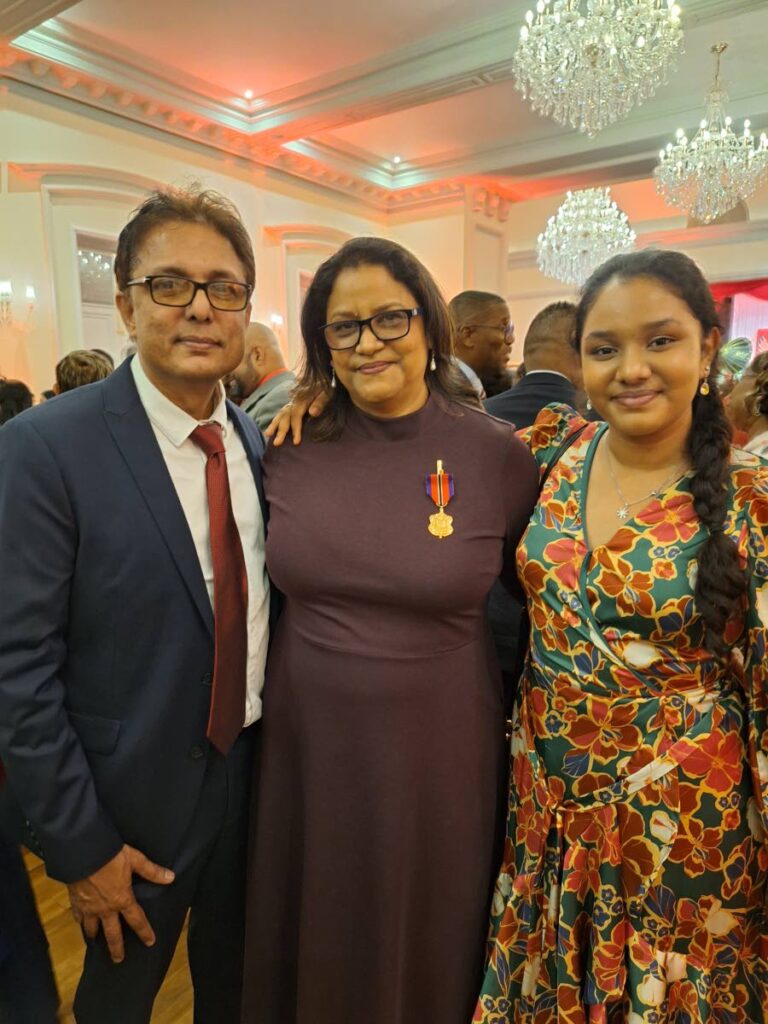 AWARDED: Lakshmi Girls Hindu College principal Sonia Mahase-Persad with her husband Anil Persad and their daughter Karishma, at President's House on September 24 - Republic Day -after Mahase-Persad was awarded the Medal of Merit (Gold). PHOTO COURTESY SONIA MAHASE-PERSAD - 