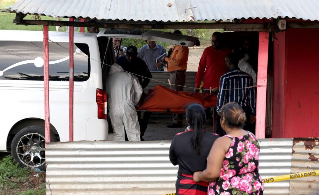 Relatives look on as undertakers remove the bodies of Tara Ramsaroop and her daughter, Jada Mootilal, who were murdered by a close male relative at a house on Rochard Road, Barrackpore on October 8.  - Photo by Roger Jacob