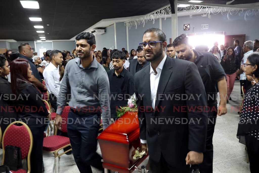 Paul-bearers carry casket of Jayden Lalchan at the start of his funeral at the JR&D Convention Centre in Princes Town, October 8. - Photo by Roger Jacob 