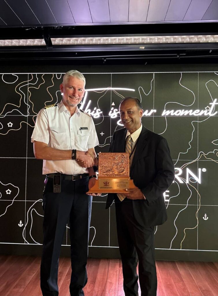 Interim Tourism Trinidad Ltd (TTL) CEO Cornell Buckradee Cornell Buckradee presenting the TT Crest to Master of the Seabourn Venture, Captain Jeroen Schuchman. - 