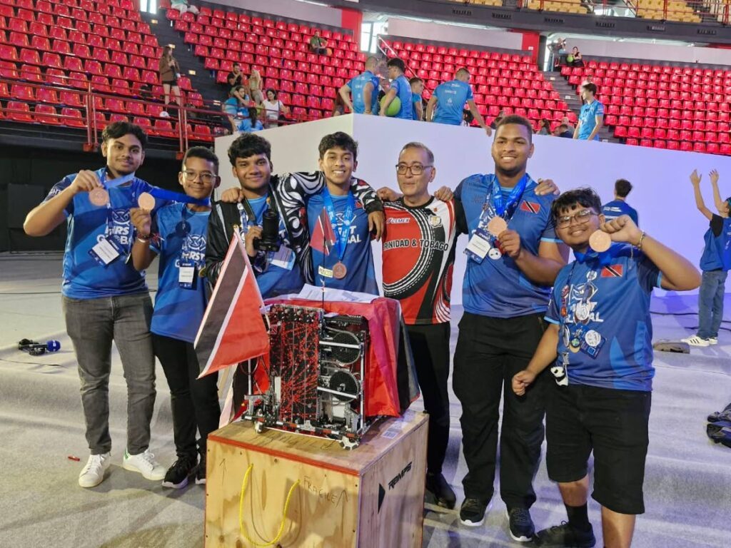 From left, Presentation College, Chaguanas students Sameer Badree, Xavier Edwards, Samrad Singh, Kovid Capildeo, the school's principal Dr Rene Wihby, and students Xavier Blache and Justin Basdeo.  - 