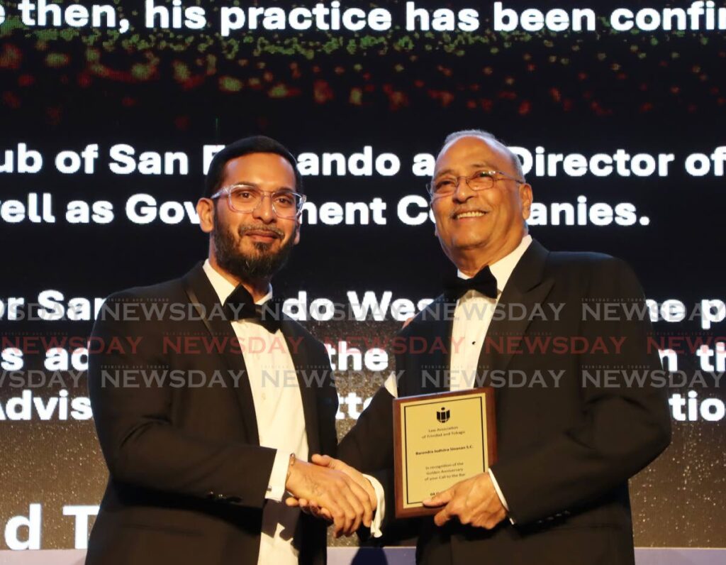 Barendra Sinanan, SC, right, receives his award from Sanjiv Boodhu. - Photo by Ayanna Kinsale 