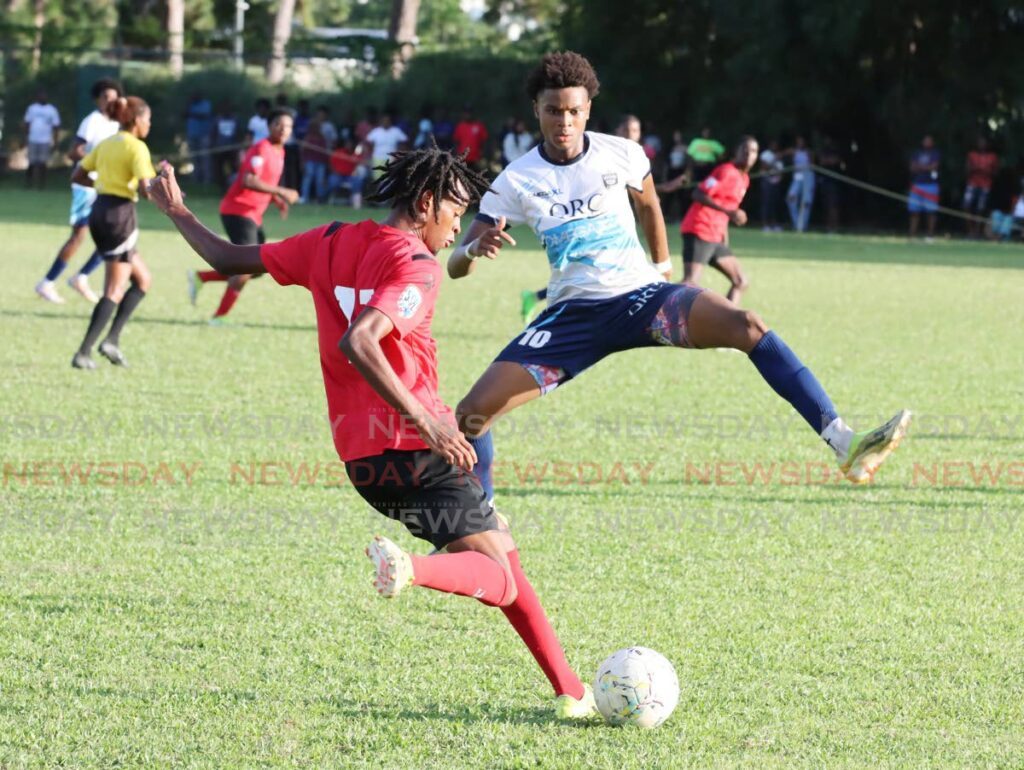 St Anthony’s College player Joshua Miller (L) and QRC’s Phillip Nelson go after the ball during the SSFL Premiership match at the St Anthony’s College Ground, Westmoorings, on October 12, 2024. - Photo by Ayanna Kinsale 