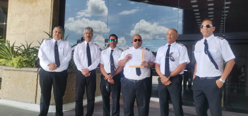 TT Airline Pilots Association (TTALPA) vice president Jason Wickham holds a letter addressed to Finance Minister Colm Imbert, which was delivered to the Finance Ministry's head office on Monday. Joining him are fellow TTALPA members. - Photo coutesy TTALPA