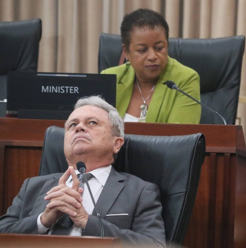 PROCESSING COLM: Finance Minister Colm Imbert gazes skyward during the Standing Finance Committee meeting in Parliament on Monday. Behind him is Minister of Public Administration Allyson West. PHOTO COURTESY OFFICE OF THE PARLIAMENT - 