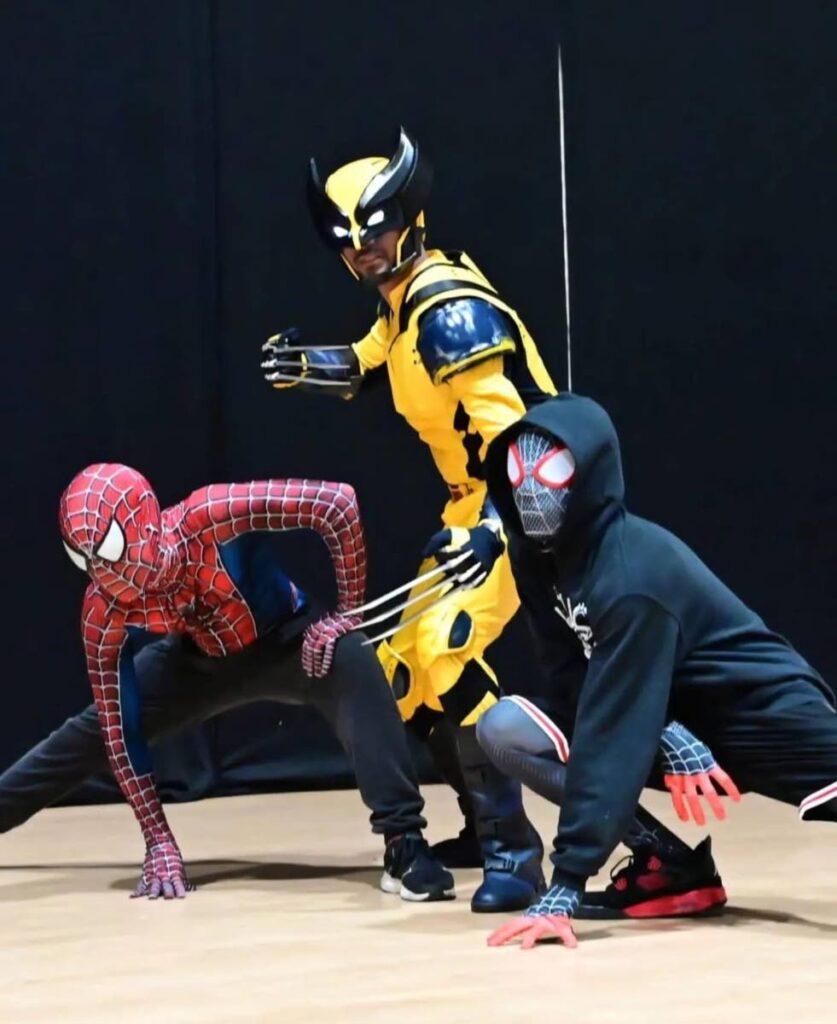  Wolverine (in yellow) with two spidermen from the Spiderverse. - 