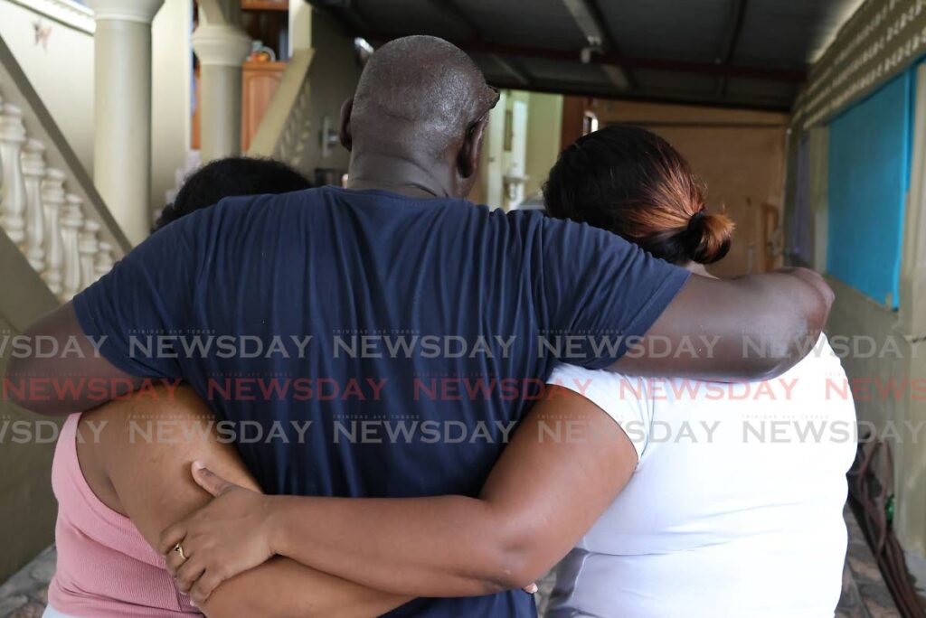 Moruga businessman Terrance Thomas and members of his family preferred to keep their faces hidden from public view on October 15, after bandits dressed in police uniform robbed and terrorised their home at Moruga Road, Preau Village, Moruga on October 14. - Photo by Roger Jacob