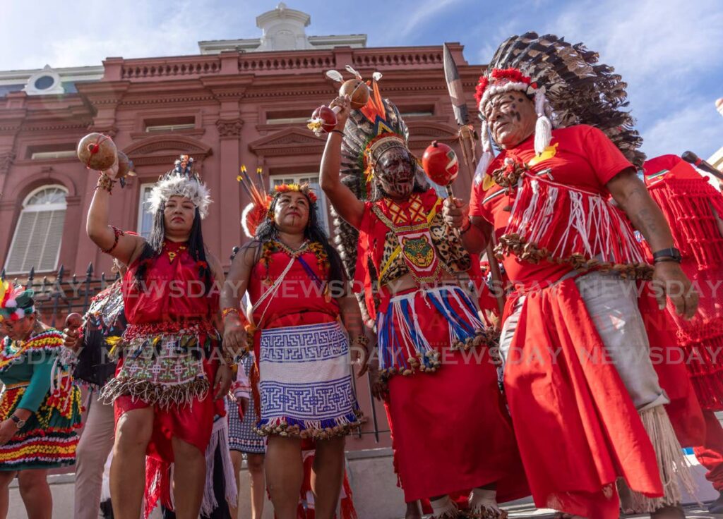 Dressed in traditional attire, Trio tribe members from Suriname sings at the 