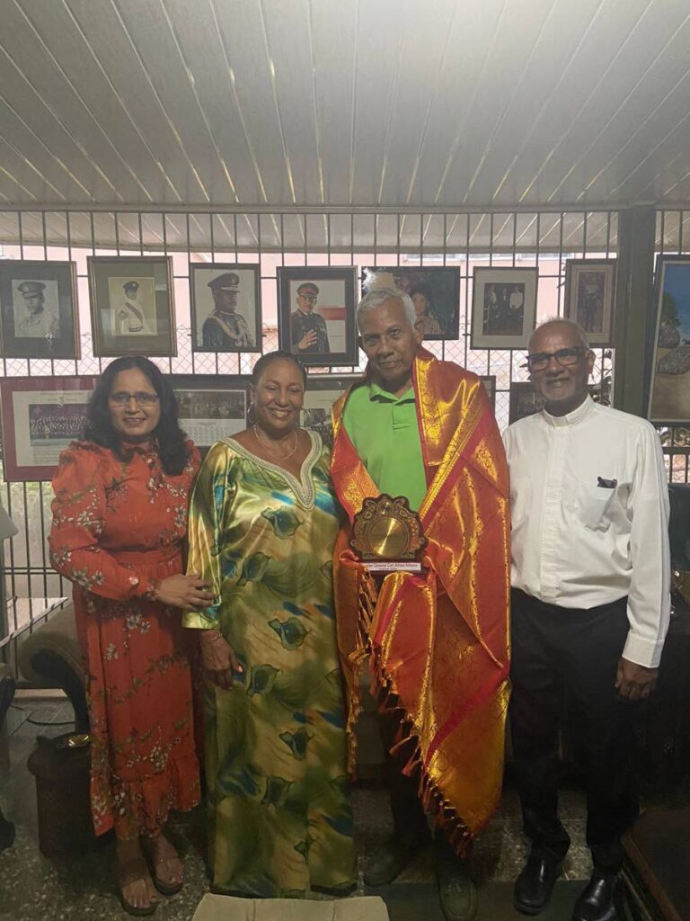 Dr Lavanya Thondawada of the Geriatric Society of TT, left, Lesley Alfonso, retired brig gen Carl Alfonso, who was honoured by the GSTT, and Fr Martin Sirju. - 