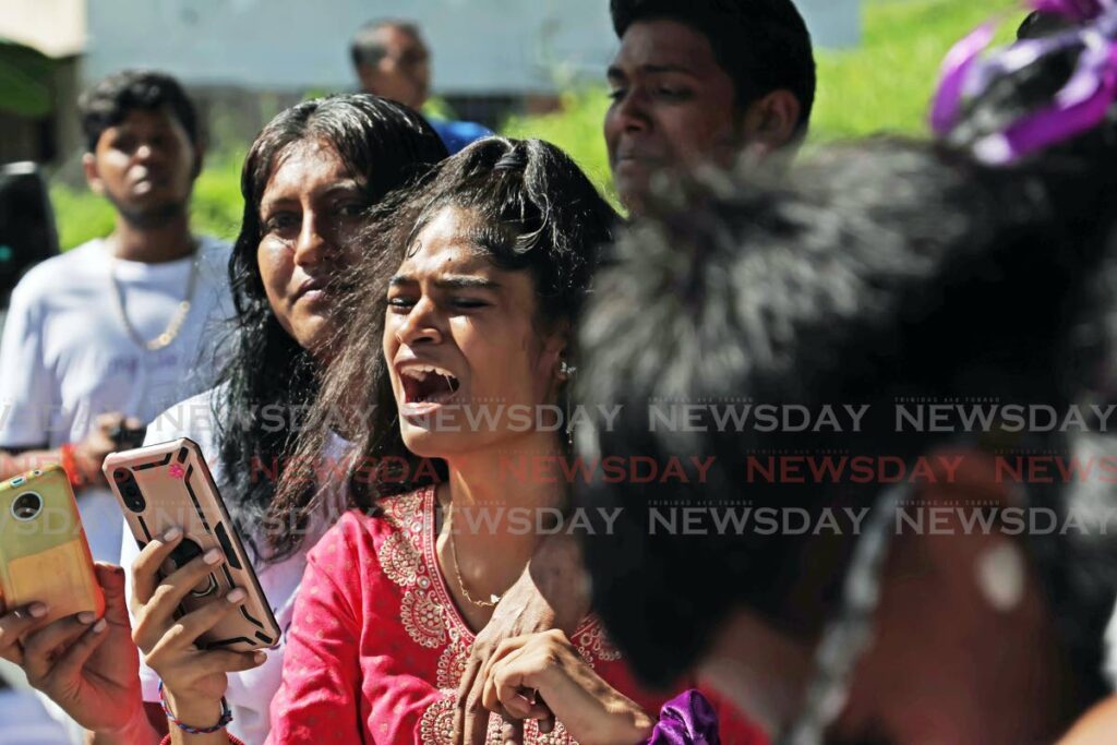 A relative weeps at the funeral service for Laura Sankar held at Post Office Trace, New Grant on October 17. - Photo by Lincoln Holder