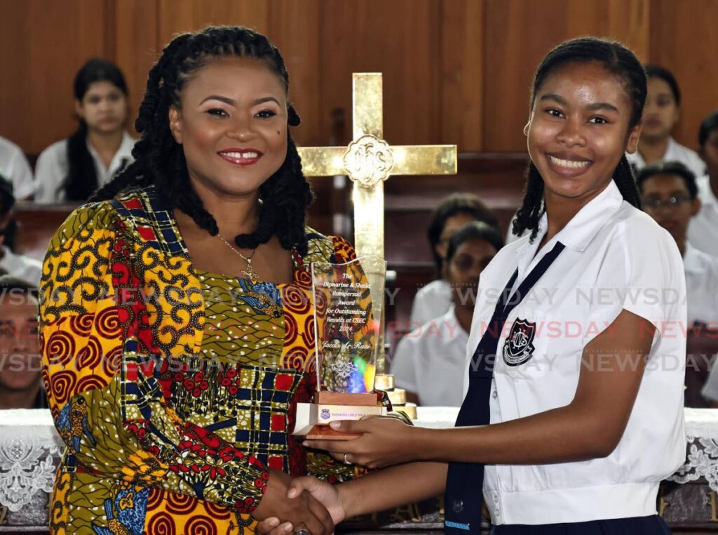 Minister of Education Dr Nyan Gadsby-Dolly, left, presents Naparima Girls' High School student Jaeda Ar-Razi with the Dipnarine and Sheila Rampersad Award for the most outstanding results at CSEC at the school's special awards ceremony at the Susmachar Presbyterian Church, San Fernando, on October 18. - Photo by Lincoln Holder 