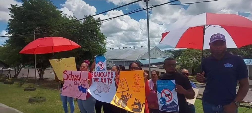 Parents stage a peaceful demonstration outside Preysal Secondary school on October 18. PHOTO COURTESY KRIS BALKARANSINGH - 