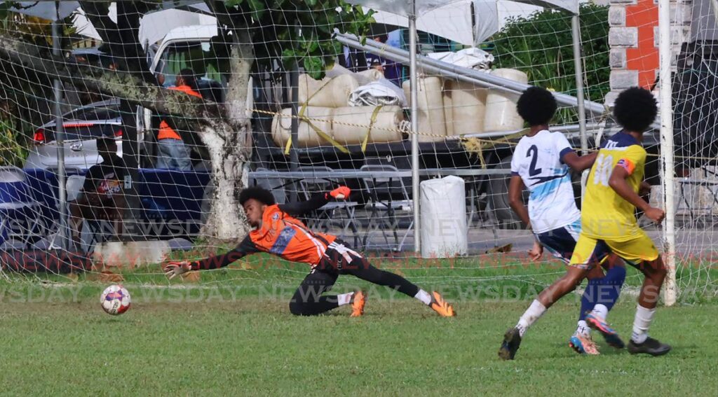 Queen’s Royal College goalkeeper Jaheim Affan fails to prevent a goal from Trinity College East’s Khaleem Prince (R) during the Secondary Schools Football League premiership division match, on October 19, at the Queen’s Royal College Grounds, Port of Spain.  - Photo by Roger Jacob 