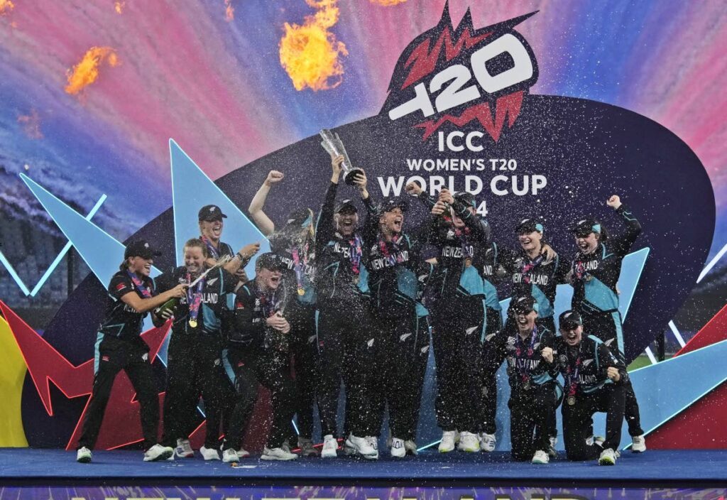 New Zealand women celebrate with the T20 World Cup trophy after beating South Africa at the Dubai International Cricket Stadium on October 20.  - AP