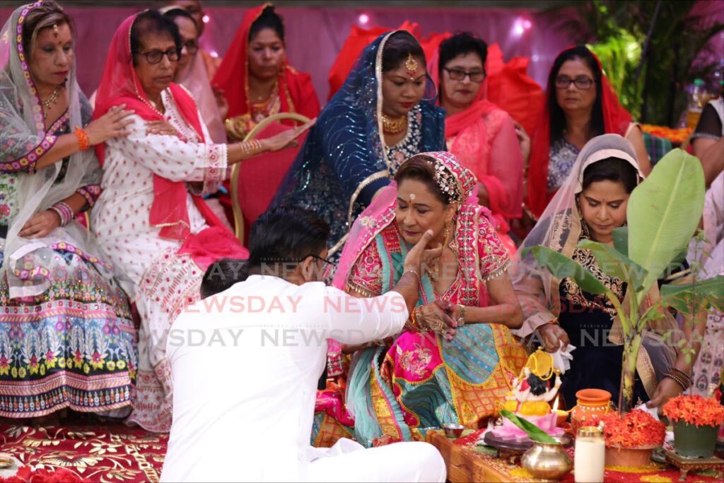 Opposition Leader Kamla Persad-Bissessar partakes in puja with members of the Siparia Women's Association led by Pundit Sunil Seetahal Maharaj at her Siparia constituency office in Penal on October 20. 
 - Jeff K Mayers