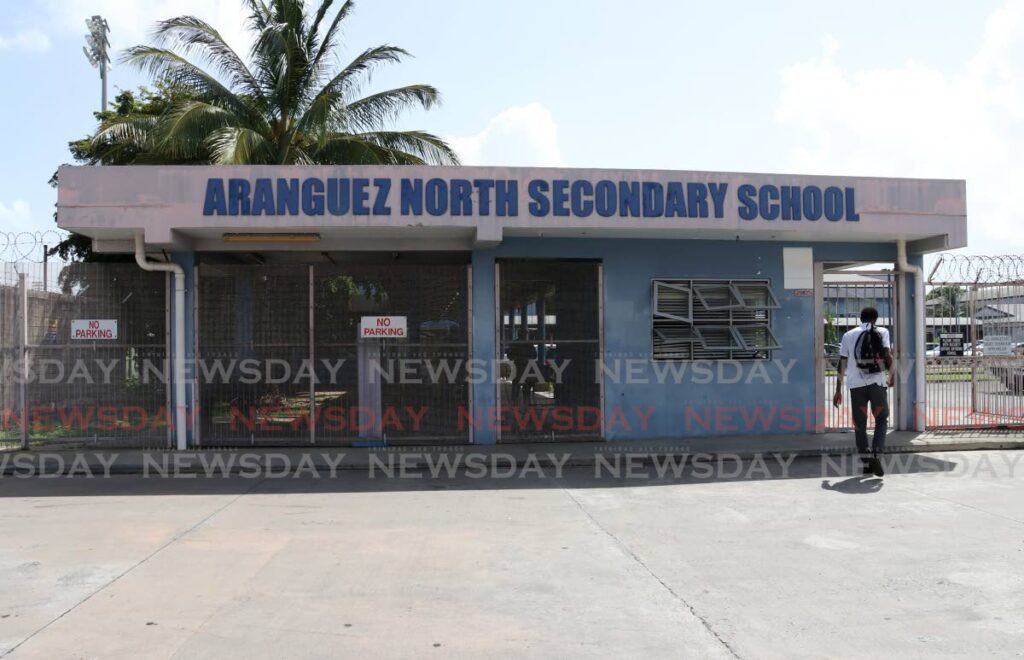 A student walks onto the school compound at Aranguez North Secondary School on Boundary Extension Road, San Juan on October 21. - Photo by Faith Ayoung