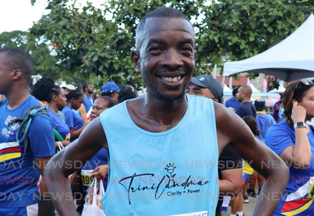 Kenyan Alex Ekesa smiling on October 20 after crossing the line first at the RBC Run for Kids 15K in St Clair. - Photo by Roger Jacob