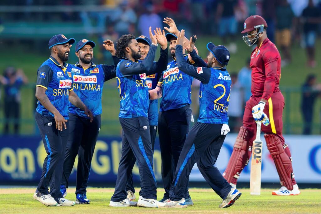 Sri Lanka’s Wanindu Hasaranga (C) celebrates the wicket of West Indies’ Romario Shepherd (R) during the second ODI in Pallekele, Sri Lanka, on October 23. (AP Photo) - 