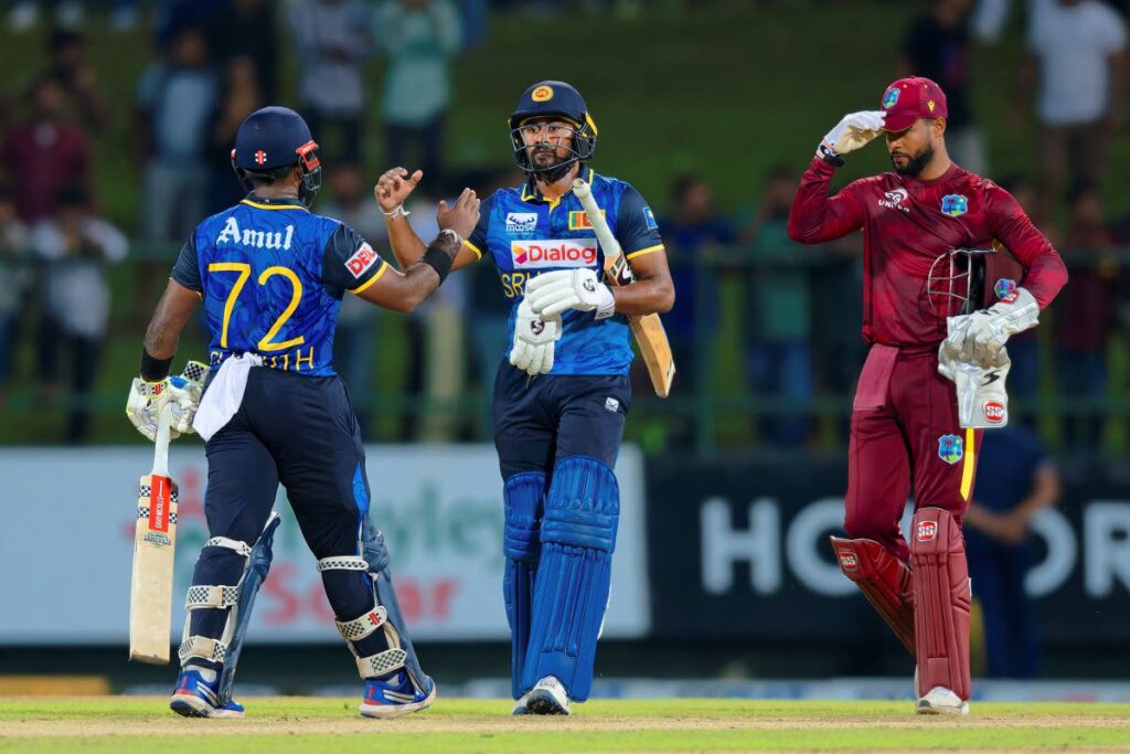 Sri Lanka's captain Charith Asalanka (L) and Kamindu Mendis celebrate their win in the second ODI against West Indies in Pallekele, Sri Lanka, on October 23. - AP PHOTO