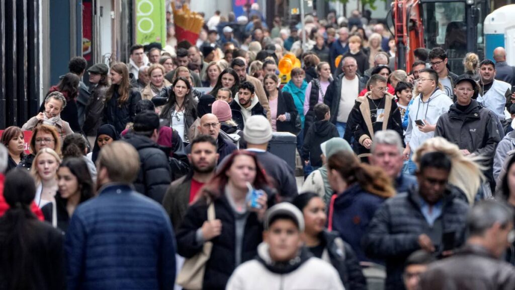 People walk along a shopping street in Dortmund, Germany, on October 24. AP Photo - 