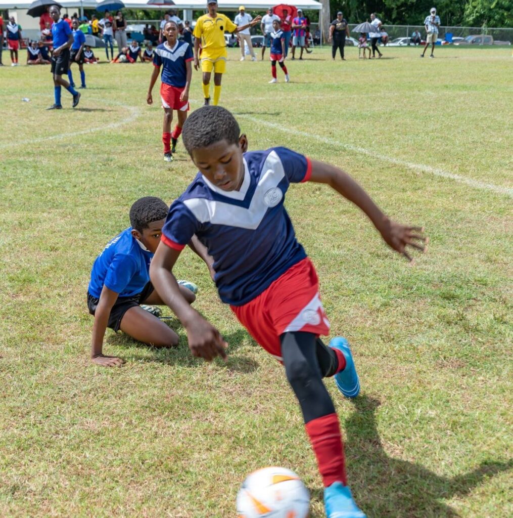 A Scarborough RC player (R) darts past a Signal Hill Government player during action in the 2024 Tobago Primary Schools football league. Photo courtesy the Division of Education, Research and Technology.  - 