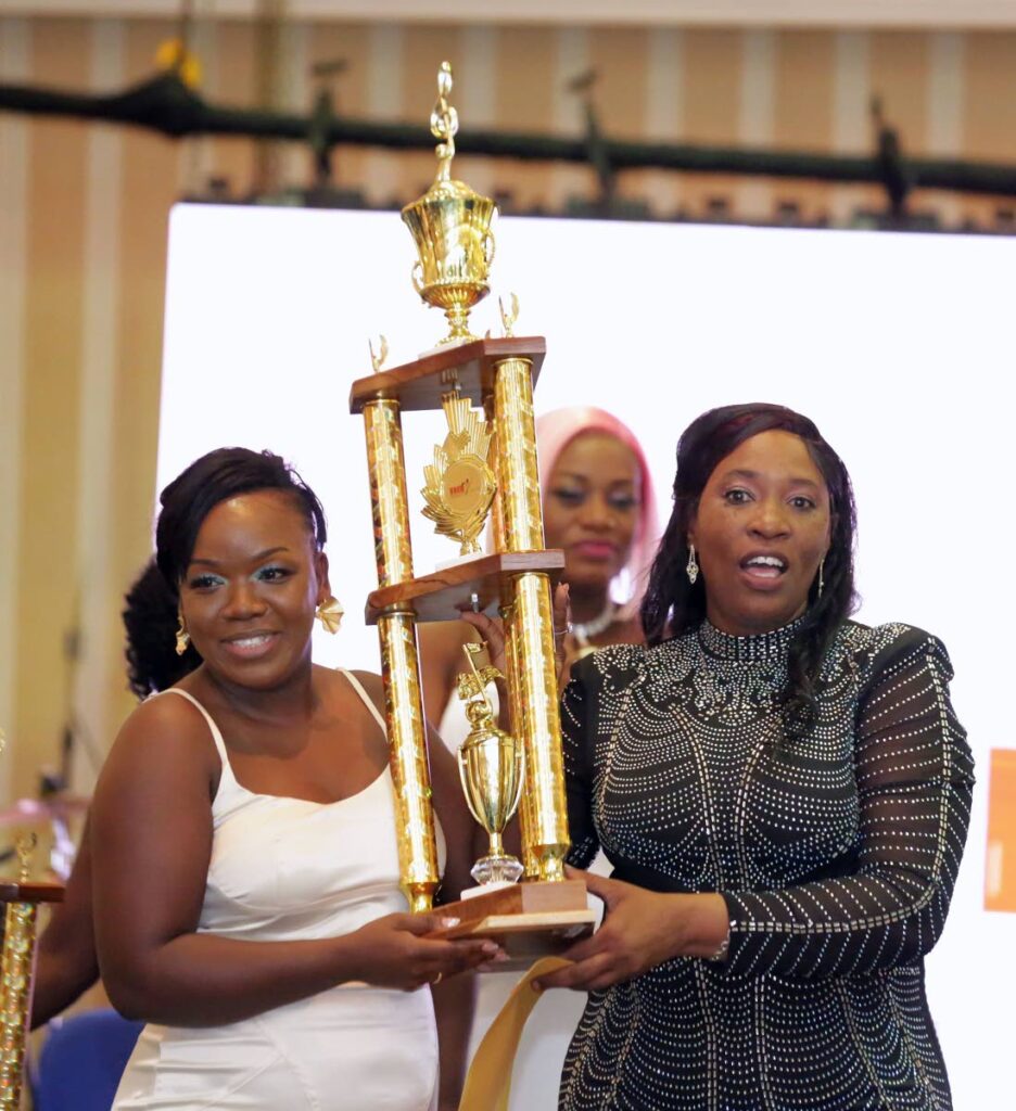 Nicole Thomas, left, collects her trophy after winning the October carnival Tobago Calypso Monarch on October 24, at Magdalena Grand Beach and Golf Resort, Lowlands. - Photo courtesy Visual Styles