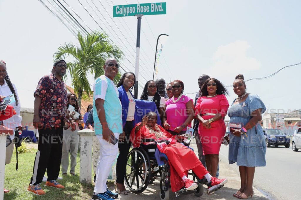 McCartha Linda Sandy-Lewis, also known as Calypso Rose takes a photo with family and friends after Old Milford Road was renamed to Calypso Rose Boulevard during the road renaming ceremony at the Esplanade, Milford Road, Scarborough on October 25. - Photo by Ayanna Kinsale