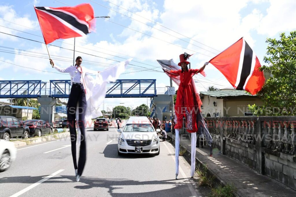 Moko jumbies lead the funeral procession of former scout commissioner for the San Fernando district Lynley 