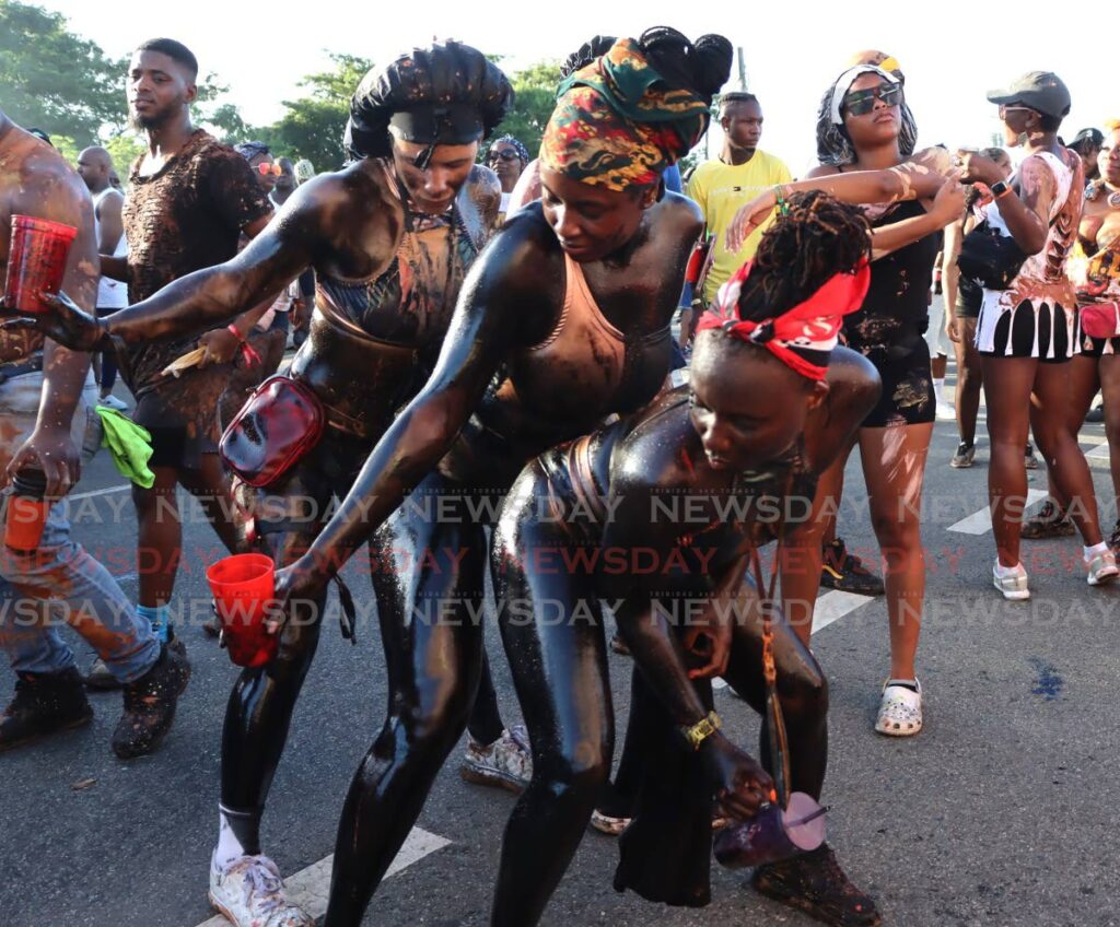 Oily revellers during J'Ouvert celebrations in Scarborough, Tobago on October 26.  - Photo by Ayanna Kinsale