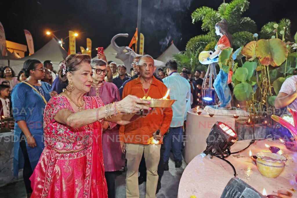 Opposition Leader Kamla Persad-Bissessar performs arti at the Divali Nagar, Chaguanas, on October 26. - Photo by Lincoln Holder 