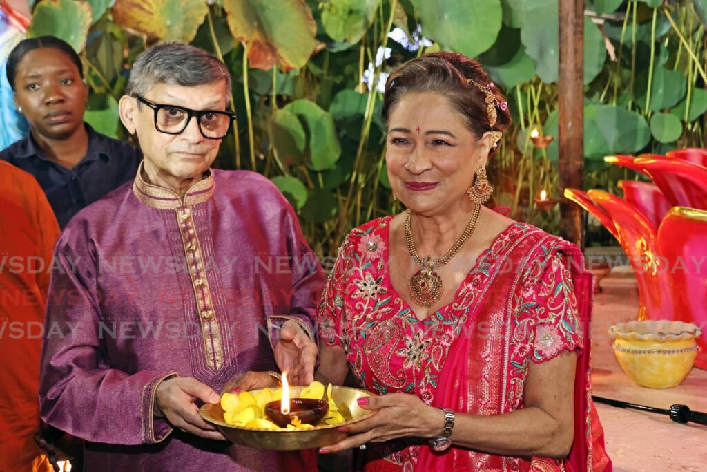 Opposition Leader Kamla Persad-Bissessar and her husband Dr Gregory Bissessar perform arti - a Hindu ritual - during the Divali Nagar programme on October 26 in Chaguanas. - Lincoln Holder 