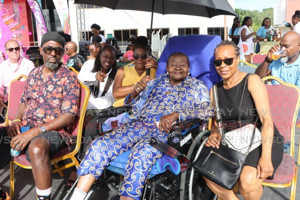 McCartha Linda Sandy-Lewis, also known as Calypso Rose, relaxes with family and friends during the Tobago parade of the bands at the Market Square Carpark, Scarborough, October 27. - Photo by Ayanna Kinsale