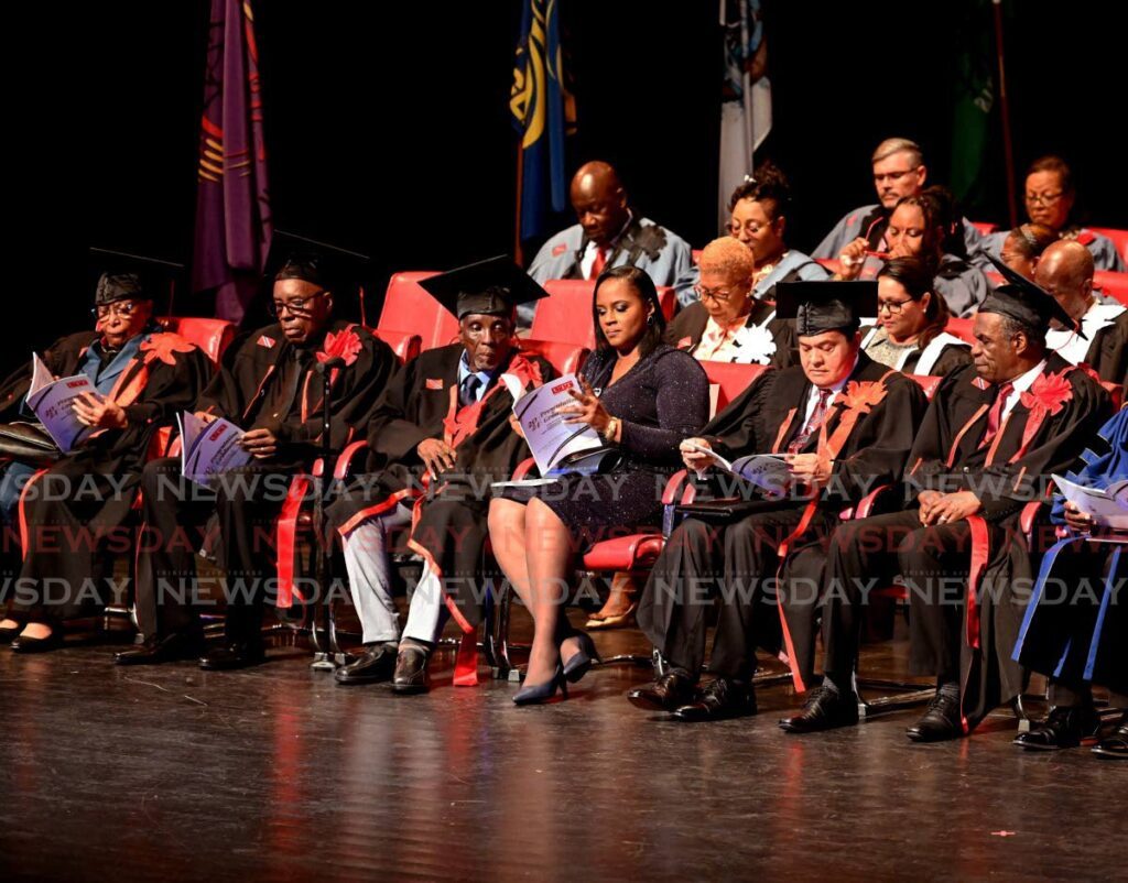 UTT honorary doctorate awardees, from left, Marilyn Gordon, of humane letters; Leon “Smooth” Edwards, of fine arts; Bertrand Kelman, of fine arts, (and a member of his family); Sieunarine Persad Coosal, of entrepreneurship and innovation; and Orville Delarno London, of humane letters at the university’s graduation ceremony at NAPA, Port of Spain, on October 28. - Photo by Faith Ayoung