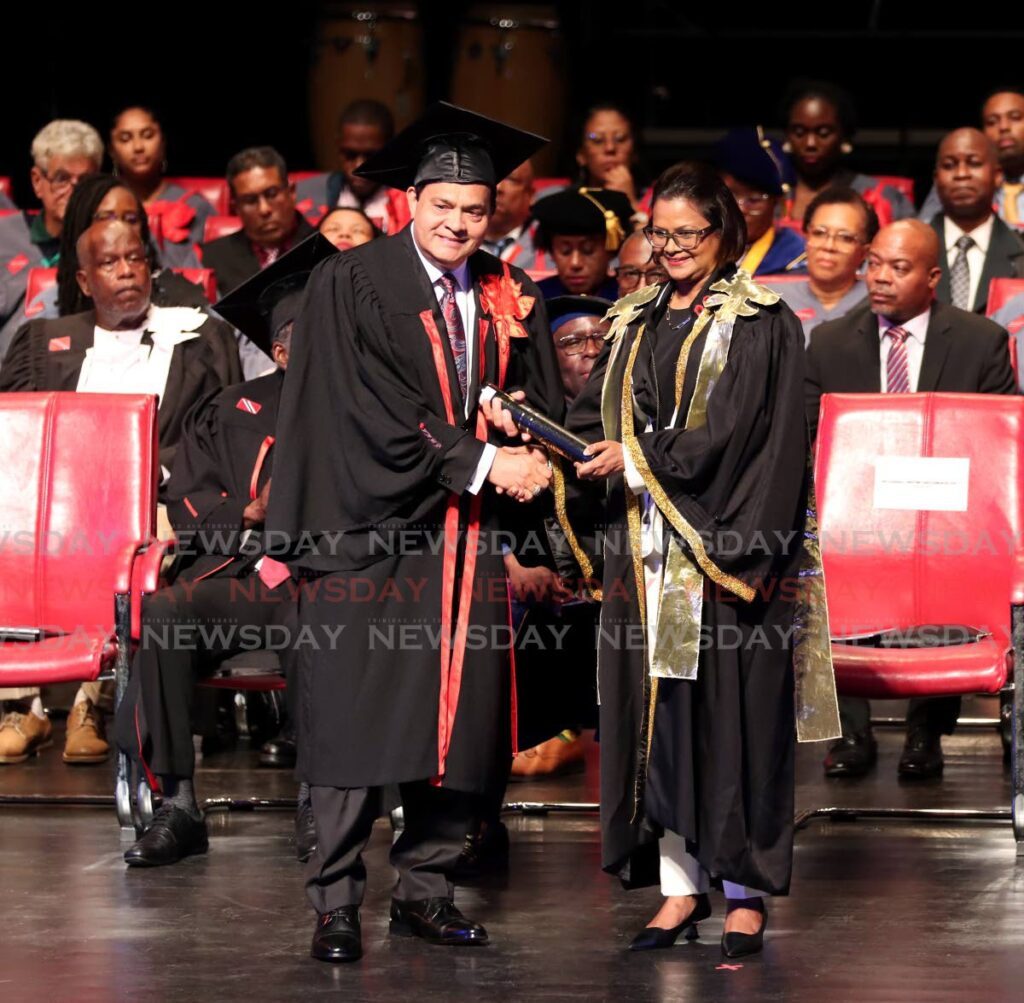 President Christine Kangaloo presents Sieunarine Coosal with his honorary doctorate for entrepreneurship and innovation at the University of Trinidad and Tobago graduation, National Academy for the Performing Arts, Port of Spain on October 28. - Faith Ayoung