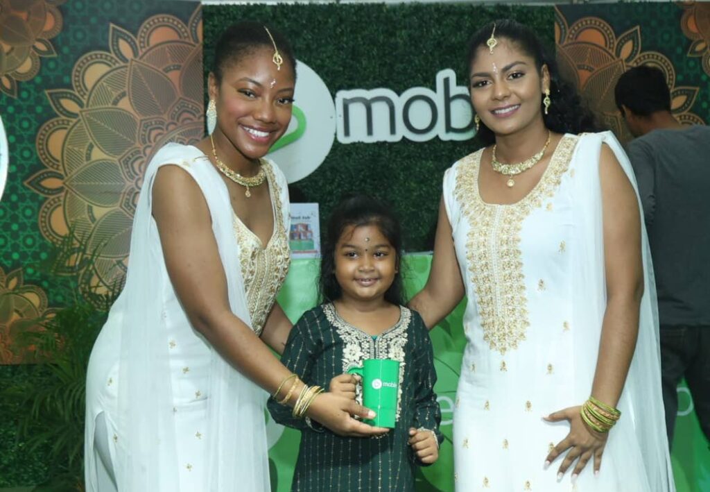 A young guest is all smiles as she is greeted by bmobile team members with a gift during a visit to the bmobile booth the National Council of Indian Culture's Divali Nagar in Chaguanas. - Photo courtesy bmobile