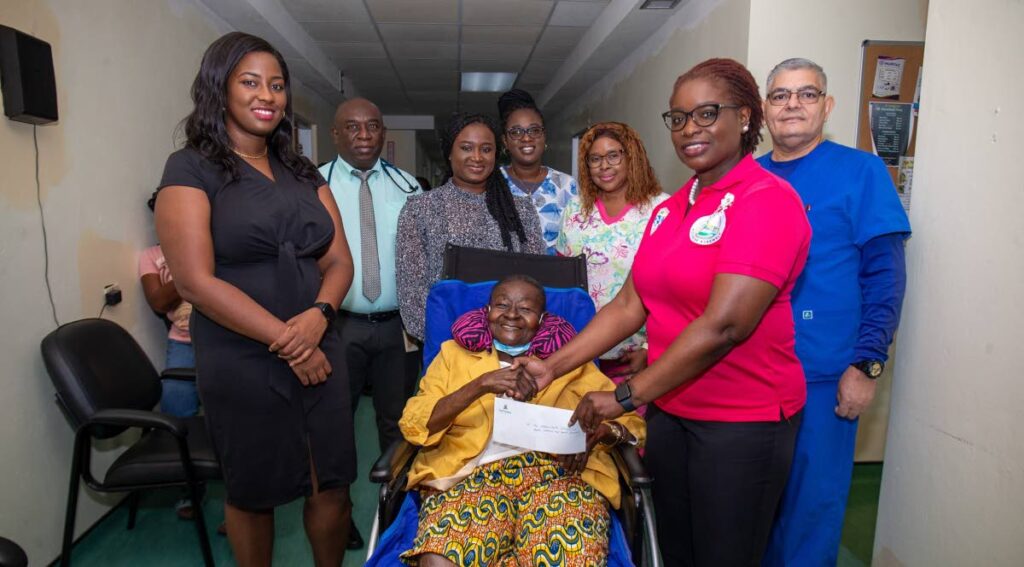 Calypso Rose, seated, is surrounded, from left, by  Dhanique Jerry, deputy chairman, TRHA Board of Directors; Dr Jorge Luis Diaz Gomez; Dr Kabeena Miguel; nurse Shaunille Roberts; head nurse Tracy Joseph-Ramsey; Dr Faith BYisrael, Secretary of Health, Wellness and Social Protection; and nurse Pedro Penate. - 