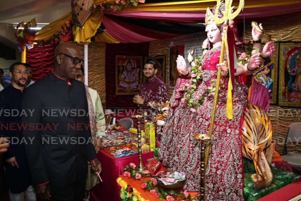 PM MEETS GODDESS: The Prime Minister admires a statue of Kali, the Hindu Divine Mother of the Universe during his visit to the Divali Nagar on October 30. - LINCOLN HOLDER