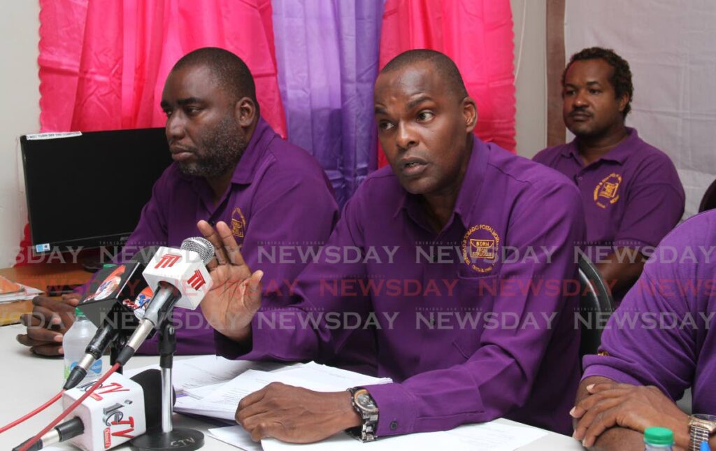 TTPost Workers Union general secretary David Forbes, centre, alongside president Shellon Trim, during a media conference in 2019. - File photo by Ayanna Kinsale