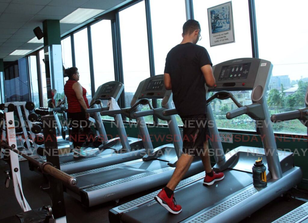 Gym members are seen walking on the treadmill at a gym in South Trinidad. File photo by Vashti Singh