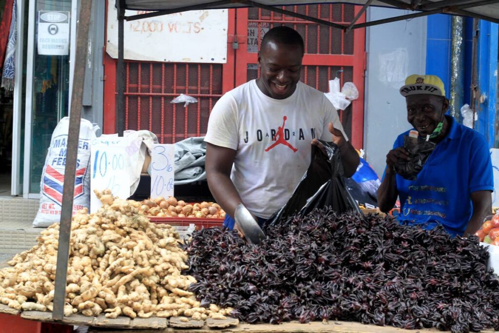 Nigel Meltz sells his fresh black sorrel and ginger on Charlotte Street, Port of Spain. - 