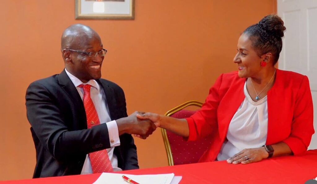 Taharqa Obika shakes hands with former PNM PRO and government senator Laurel Lezama-Lee Sing.  - FILE PHOTO 