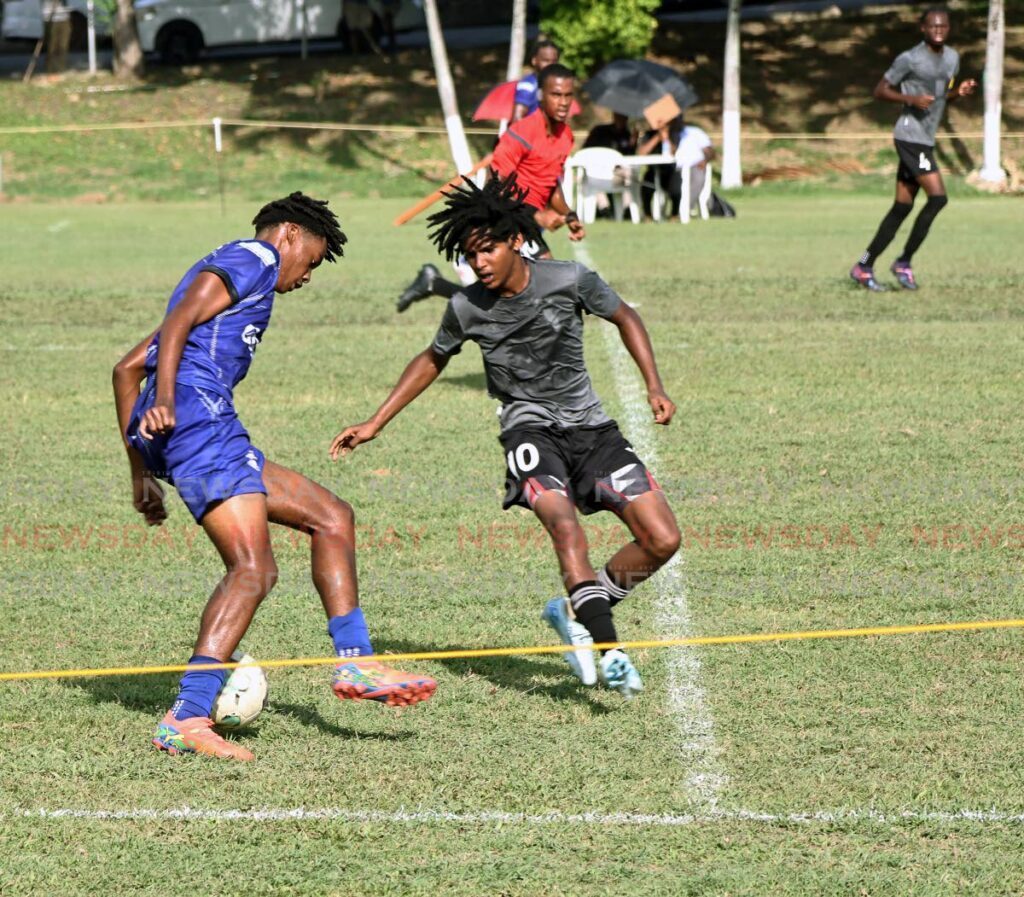 East Mucurapo’s Makai Simmons, right, in action earlier this season against Naparima College in the SSFL premiership division. - File photo