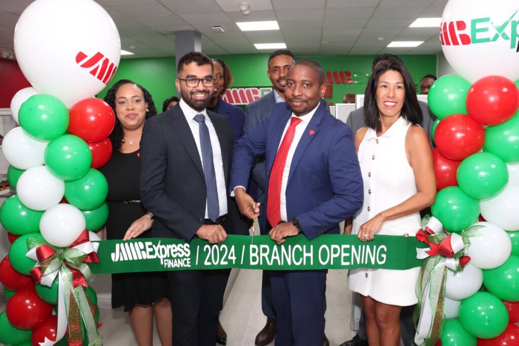 RIBBON CUTTING: Charissa Jackman, branch manager, left; Saddam Hosein, MP for Barataria/ San Juan; Elson James, CEO of JMMB Express Finance; and Lorraine Kam, chairwoman of JMMB cut the ribbon at the opening of the JMMB San Juan branch on September 26. - File photo by Faith Ayoung