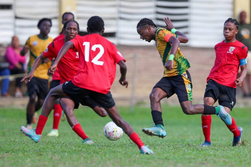 St Benedict's College's Derrel Garcia, centre, tries to weave his way through the St Anthony's defence during an SSFL Premiership match at the St Anthony's College Ground on October 7, in Westmoorings - File photo by Daniel Prentice