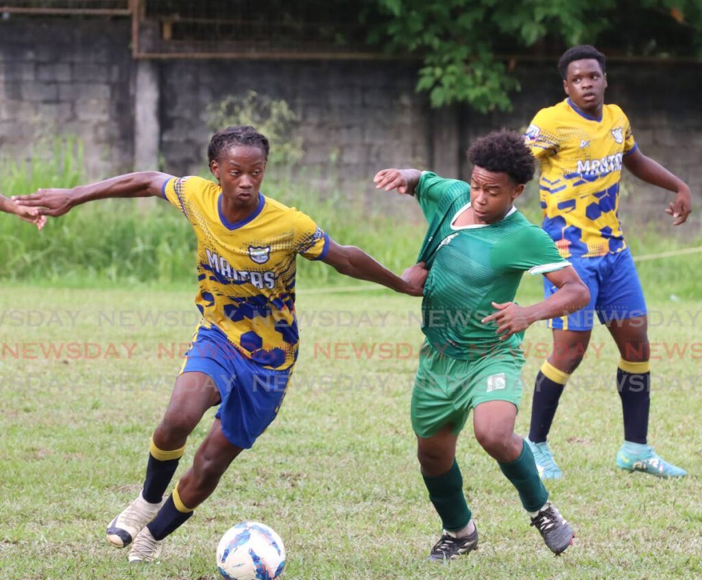 FILE PHOTO: Jamaludin Blandin of San Juan North Secondary, right, battles for the ball with Speyside High School defender Isaiah Mund in their SSFL Premiership Division match at San Juan Secondary School grounds earlier this season. 