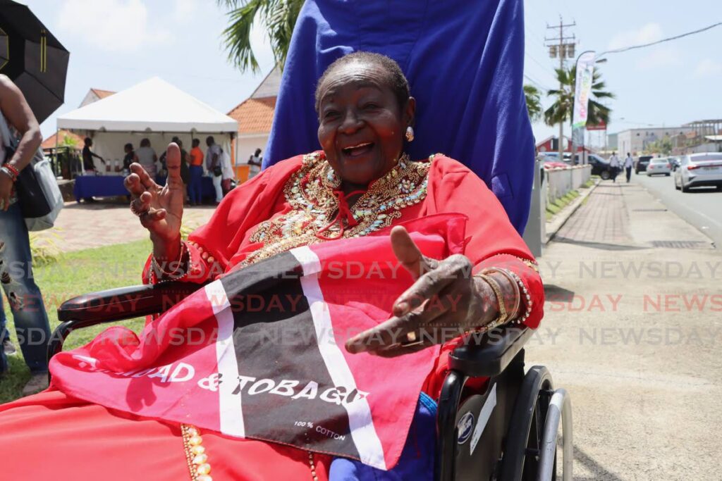 Linda McCartha  Sandy-Lewis, also known as Calypso Rose takes a photo after Old Milford Road was renamed to Calypso Rose Boulevard during the road naming ceremony at the Esplanade, Milford Road, Scarborough, on October 25. - Photo by Ayanna Kinsale 